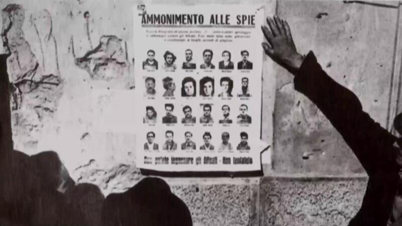 Immagine in bianco e nero che raffigura un manifesto intitolato ammonimento alle spie con la rappresentazione di vari volti